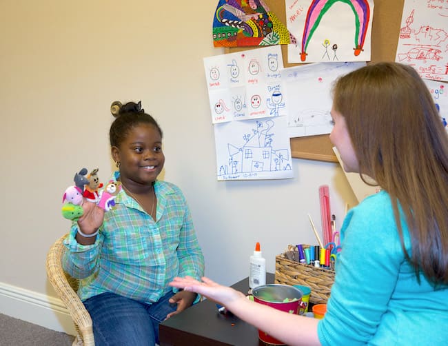 Therapist and child in play therapy session