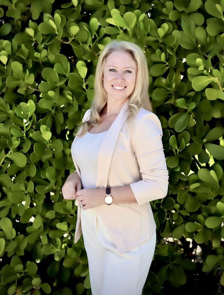 Elizabeth standing in front of a bush